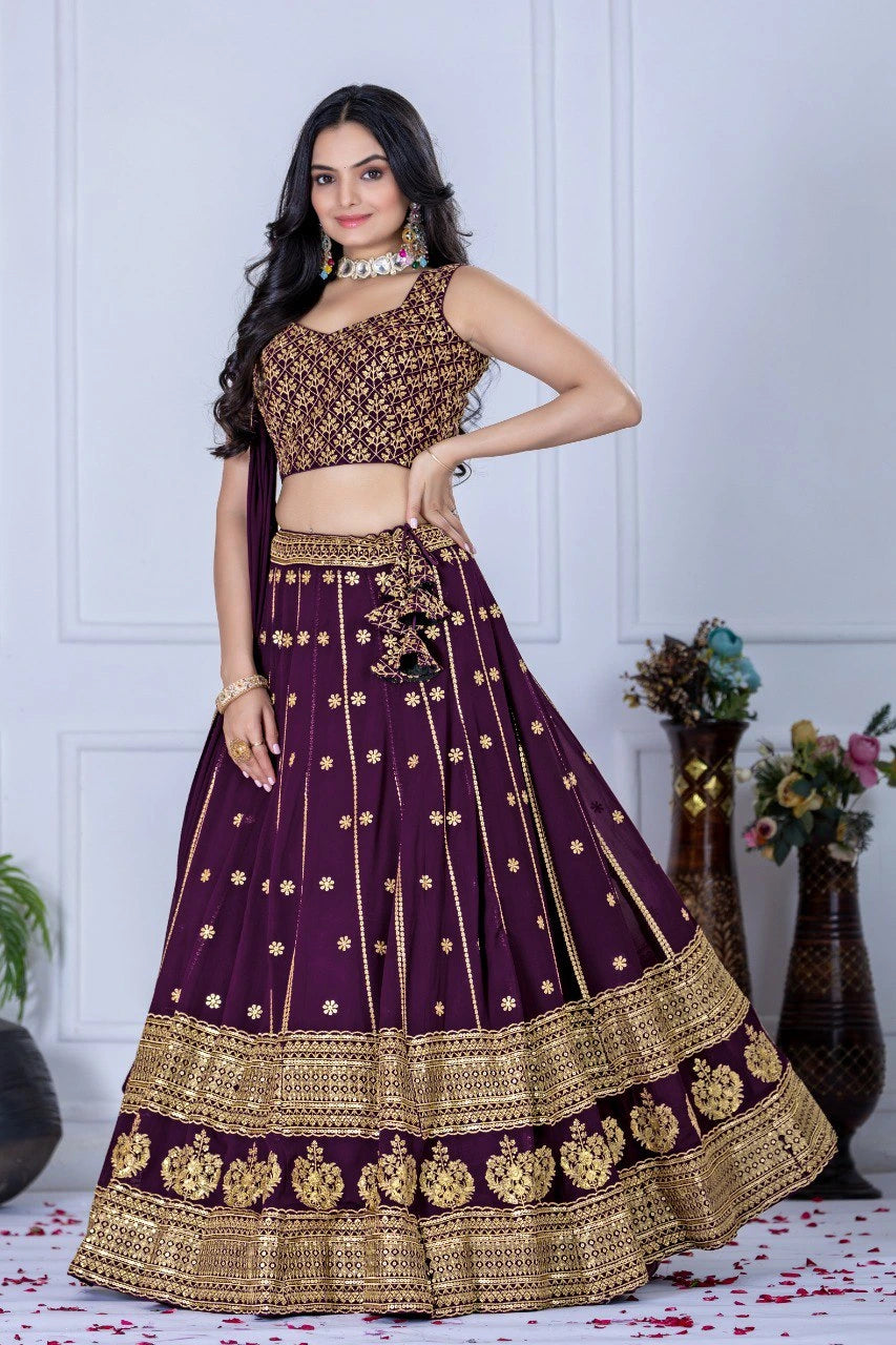 Woman wearing a traditional purple and gold outfit with floral decorations in the background